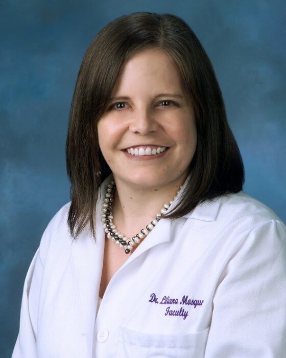Dr. Liliana Mosquera, wearing a white clinical coat.